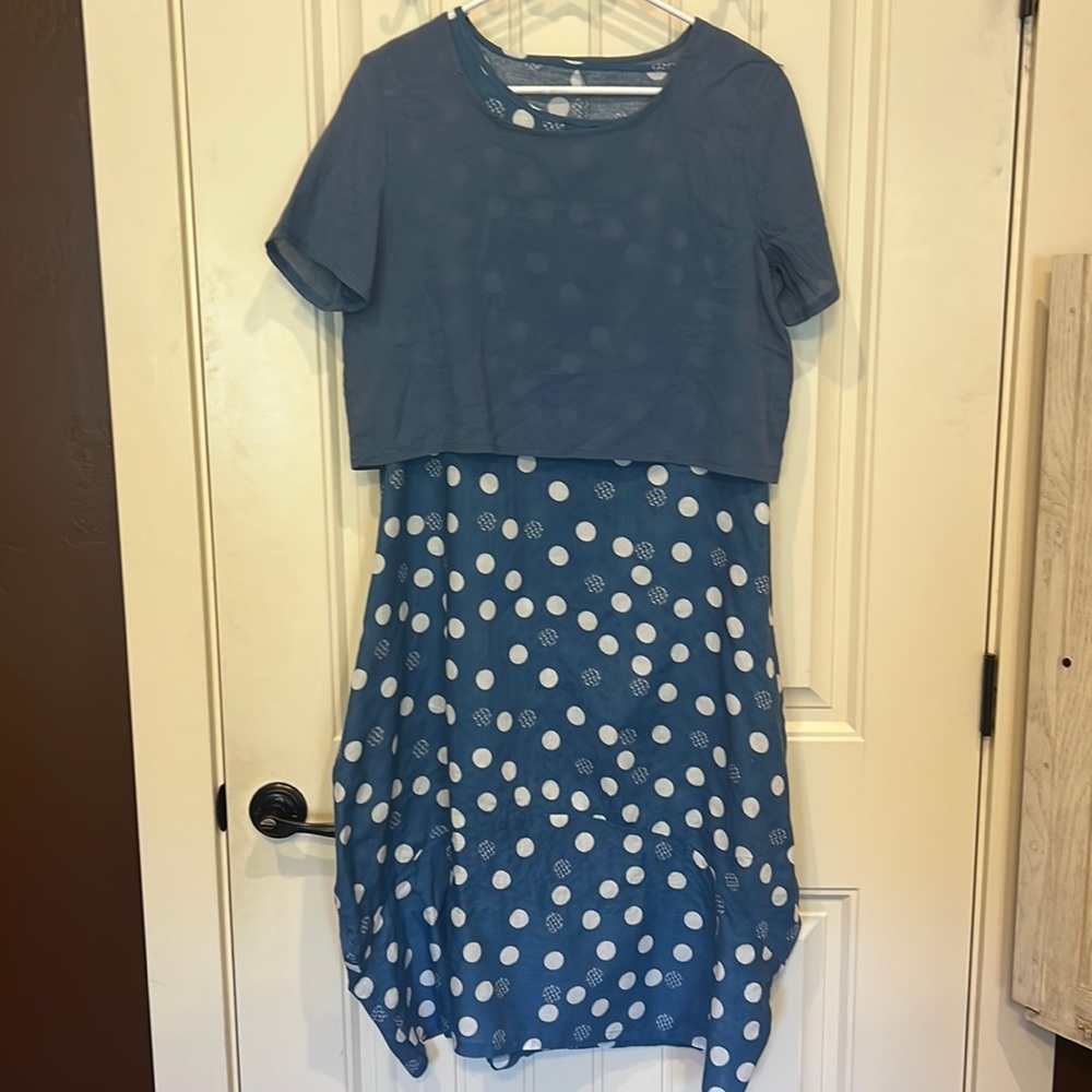 Dress is a soft baby blue w/white polkadots. With a overlay of a solid baby blue